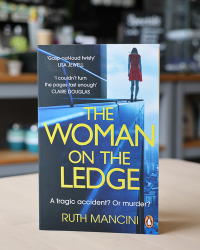 An image of the book cover for The Woman on the Ledge by Ruth Mancini