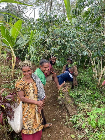 An image of coffee farmers smiling.
