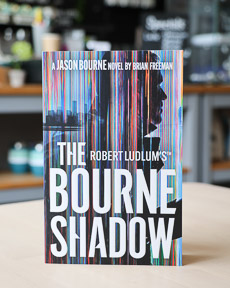 An image of the book cover for Robert Ludlum's The Bourne Shadow by Brian Freeman